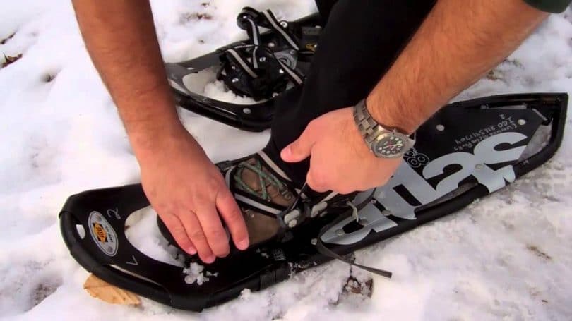 Putting on snowshoes