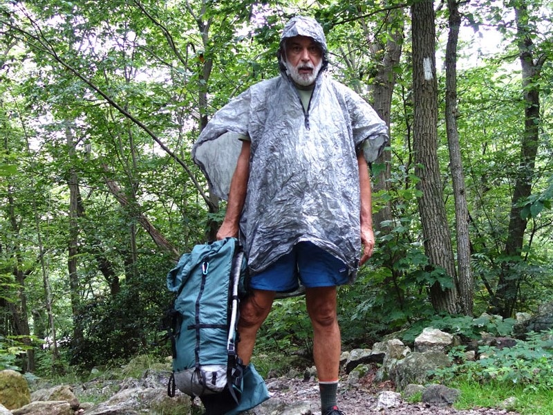 Man hiking and wearing a gore tex poncho