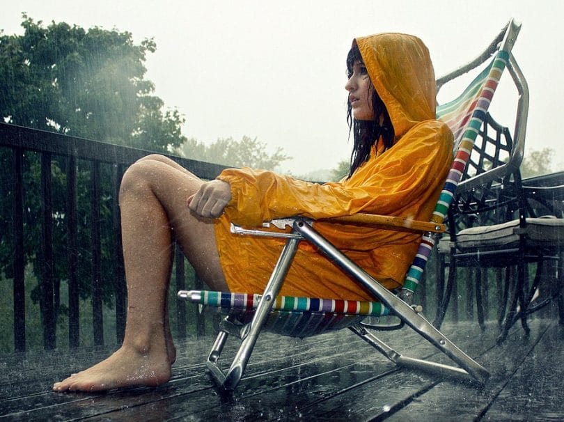 women standing in a chair in the rain