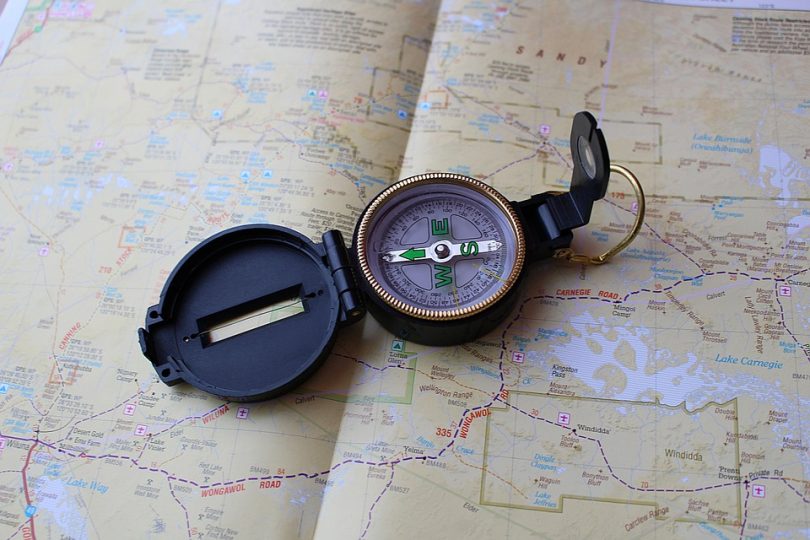 Black compass on map