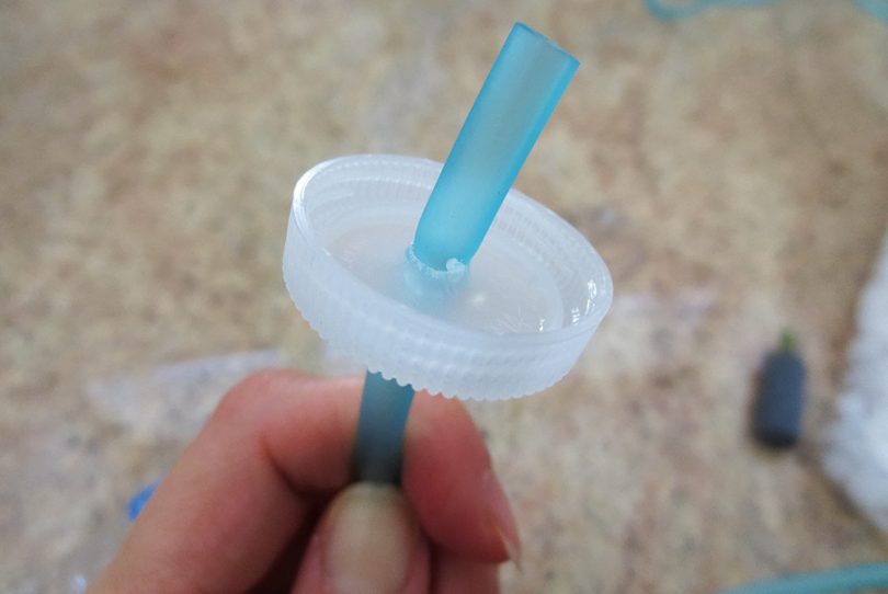 Attaching tubing into bottle