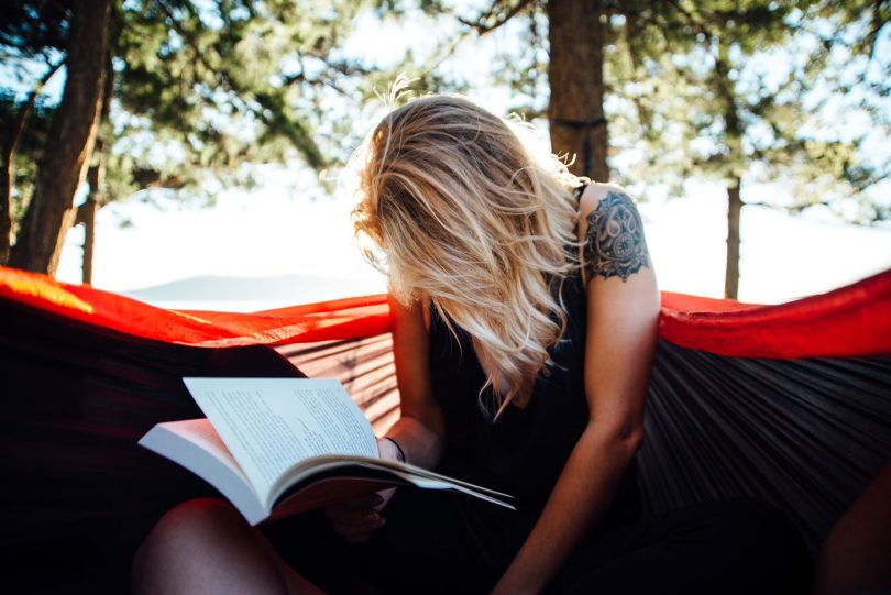 Woman reading hiking and adventure book