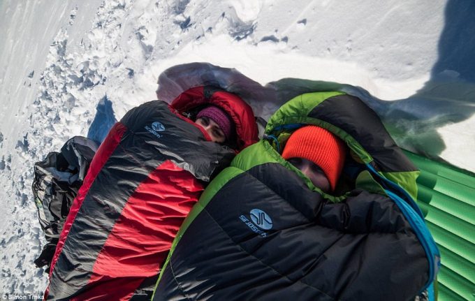 Couple in sleeping bags outdoors