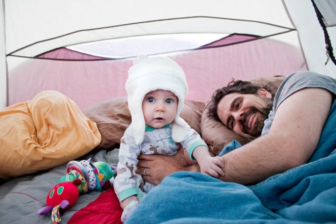 Little baby with father in camp tent