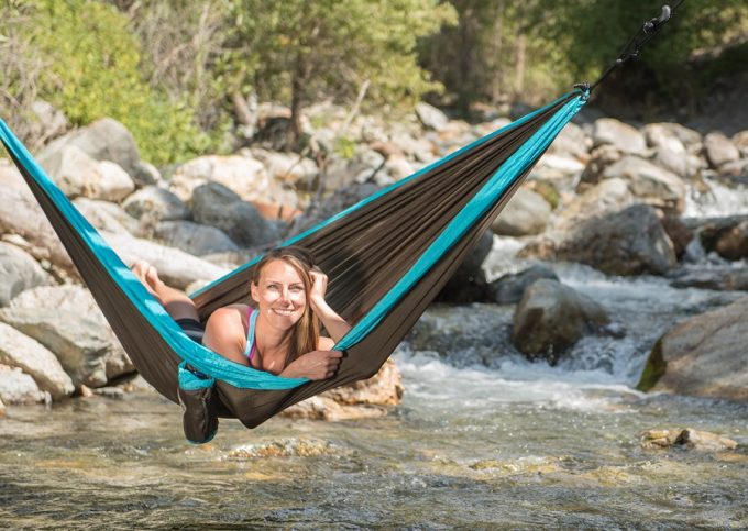 Relaxing in hammock over river
