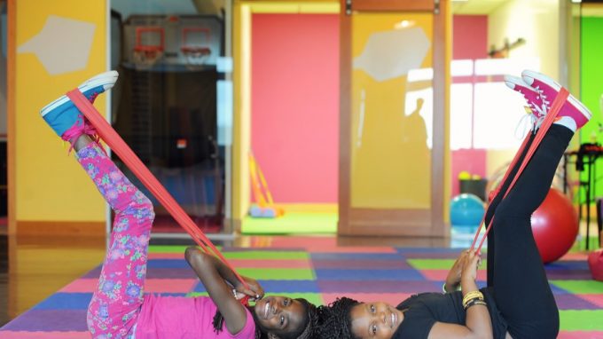 two girls exercising with resistance bands