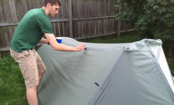 A-man seam sealing his tent