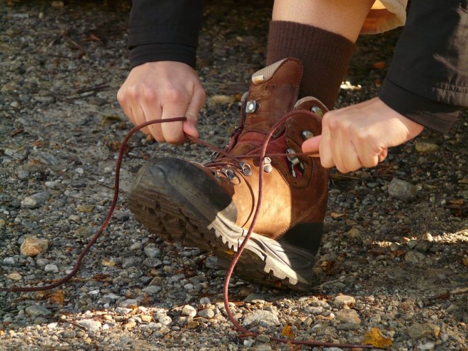 Hiker tying his boots in forest