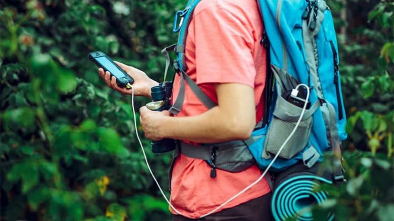 Hiker using smartphone app on travel