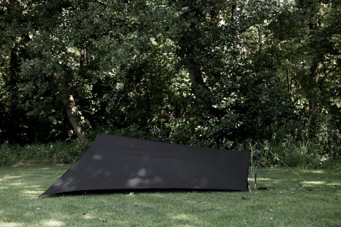 black tarp tent on grass