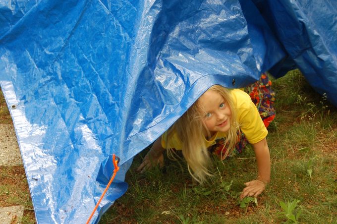 little girl under tarp tent