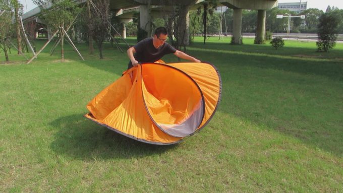 man folding a tent