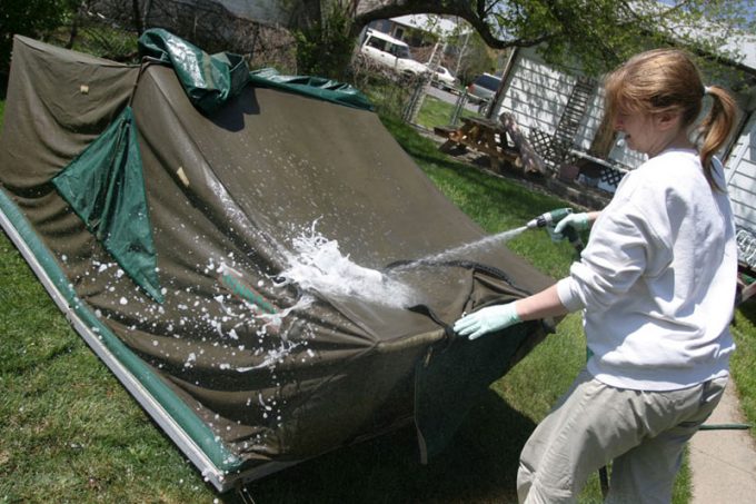 woman cleaning a tent