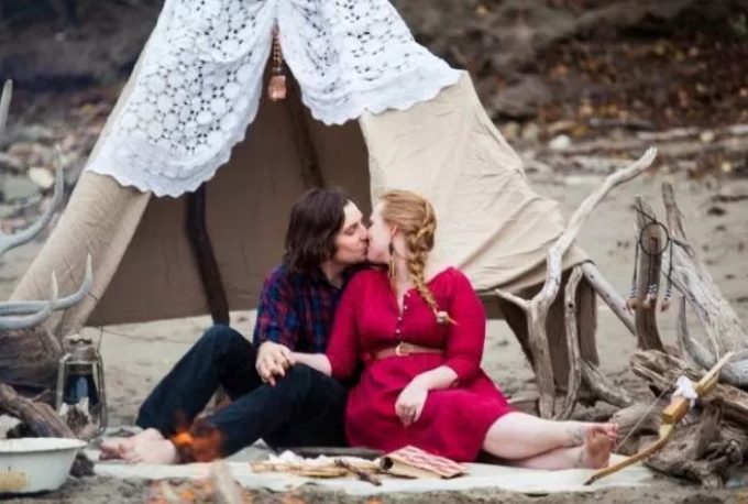 couple in front of tent kissing