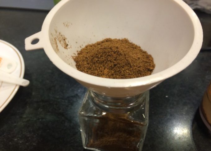 pouring spices with funnel