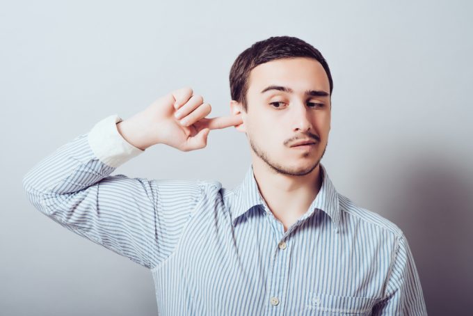 man with finger in his ear